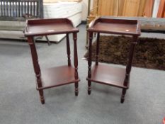 A pair of two tier telephone tables