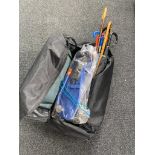 A holdall containing assorted walking sticks, umbrellas,