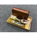 A box of leather cased gent's travel set, tea cards, brooches, Victorian copper coins,