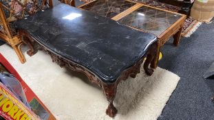 A shaped continental style coffee table on claw and ball feet