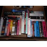 A box of hardback and paperback books; novels including Peter James,