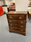 A Georgian style mahogany four drawer chest on bracket feet with turnover top leather inset panel