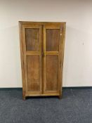 A 1930's oak Gentleman's wardrobe by Beavan of Newcastle