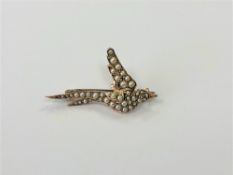 A 15ct gold pearl set swallow brooch