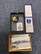 Two boxes of a small quantity of vintage postcards, military buttons,