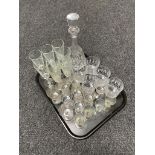A cut glass decanter together with a tray of assorted glass