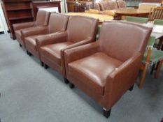 A set of four contemporary brown leather armchairs