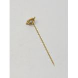 A high carat gold pin set with a good quality diamond approximately 0.25ct, 1.8g.