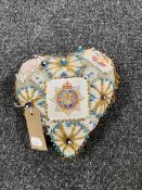 A heart shaped sweetheart pin cushion,