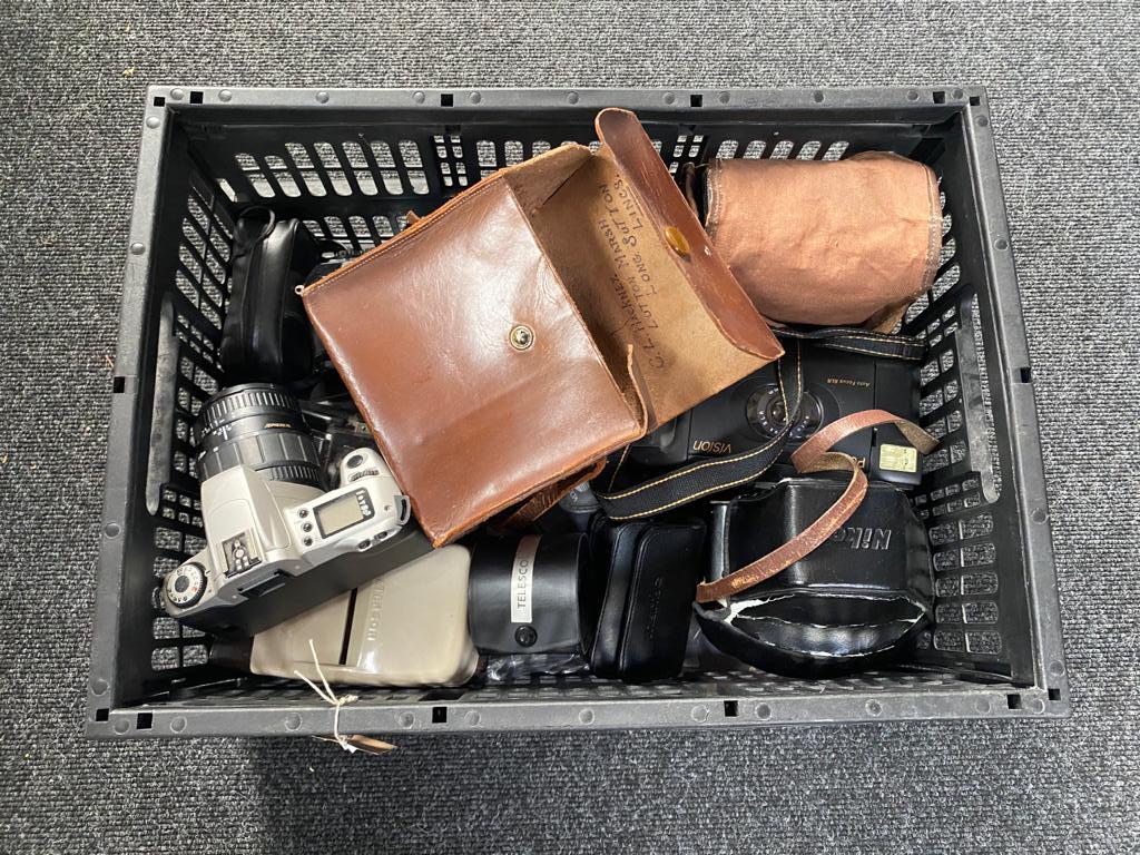 A crate of a quantity of assorted cameras and accessories
