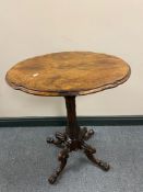 A Victorian carved rosewood wine table on four way pedestal