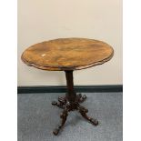 A Victorian carved rosewood wine table on four way pedestal