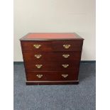 A reproduction mahogany five drawer chest with brass dropped handles and tooled leather inset panel