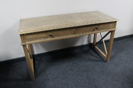 A twentieth century oak two drawer writing table CONDITION REPORT: 130cm wide by