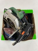 A box of assorted power tools, Hitachi circular saw, Black and Decker sander,