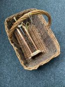 A wicker basket containing a copper Art Nouveau companion stand and two companion pieces