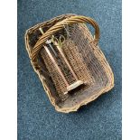 A wicker basket containing a copper Art Nouveau companion stand and two companion pieces