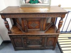 An Edwardian carved oak court cupboard