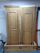 A triple door pine wardrobe fitted with two drawers (dismantled)