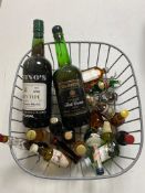 A basket of bottle of Justinos Madeira wine, Bristol cream,