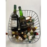 A basket of bottle of Justinos Madeira wine, Bristol cream,