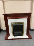 A brass framed electric fire in surround