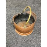 An antique copper brass handled coal bucket