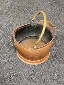 An antique copper brass handled coal bucket