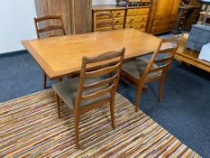 A teak G-plan refectory dining table together with a set of four ladder backed chairs