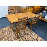 A teak G-plan refectory dining table together with a set of four ladder backed chairs