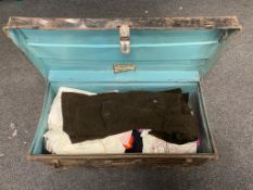 An early twentieth century tin trunk containing vintage clothing