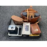 A tray of two sets of leather cased binoculars; Swift and Denhill,