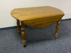 A twentieth century pine drop leaf kitchen table