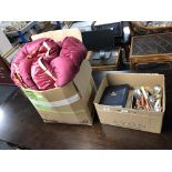 A box containing table linen, vintage quilt and bed cover,