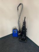 A Panasonic upright vacuum together with a Miele vacuum