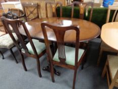 An inlaid mahogany drop leaf table and four Edwardian inlaid mahogany dining chairs