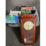 A plastic storage crate with lid containing a battery wall clock leather brief case, socket set,