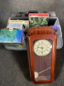 A plastic storage crate with lid containing a battery wall clock leather brief case, socket set,