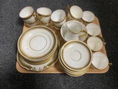 A tray of antique white and gilt tea service