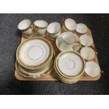A tray of antique white and gilt tea service