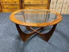 A circular G-plan teak coffee table with glass panel