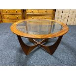 A circular G-plan teak coffee table with glass panel