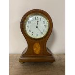 An inlaid mahogany balloon mantel clock with enamel dial on brass feet