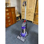 An upright vacuum together with an angle poise floor lamp and a halogen heater