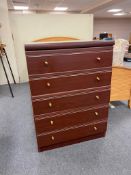 A mahogany effect five drawer chest
