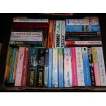 A box of hardback and paperback books; novels to include Larsson,