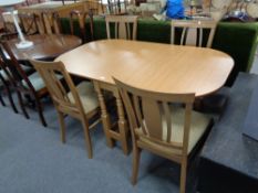 An H J Berry drop leaf table together with a set of four chairs