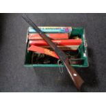 A box of mid century and later board games, plastic rifle,
