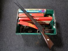 A box of mid century and later board games, plastic rifle,
