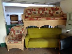 A wicker three seater conservatory settee with armchair